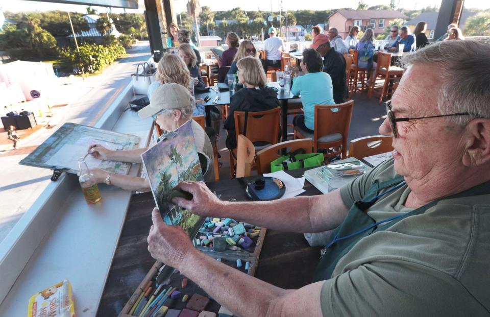 Artists Preston King and Catherine Hills work in the crowded restaurant, Tuesday, Oct. 17, 2023, during the New Smyrna Beach Plein Air Paint Out at the Avanu on Flagler.