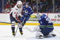 Washington Capitals' Alex Ovechkin (8) is stopped by Vancouver Canucks goalie Spencer Martin (30) during the third period of an NHL hockey game Tuesday, Nov. 29, 2022, in Vancouver, British Columbia. (Darryl Dyck/The Canadian Press via AP)