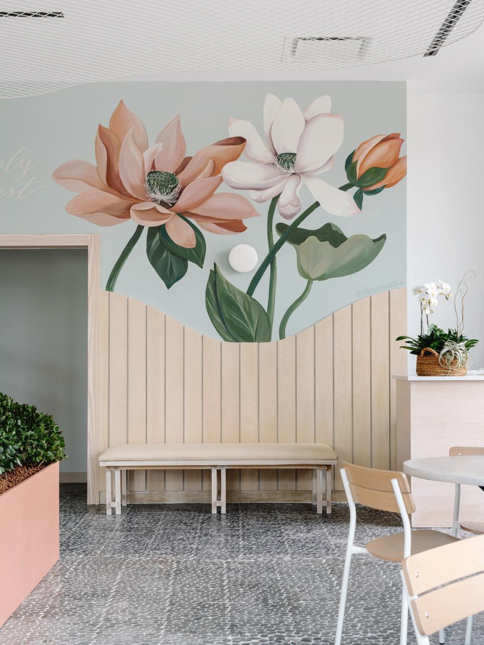 It was the owners' idea to do a mural; Connie went with lotus flowers in the same peach tone that is seen on the planters.