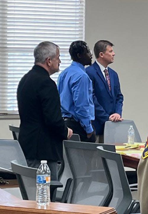 Murder suspect Tajmon Robinson, center, is seen with his attorneys at his trial in 30th District Court on Wednesday.