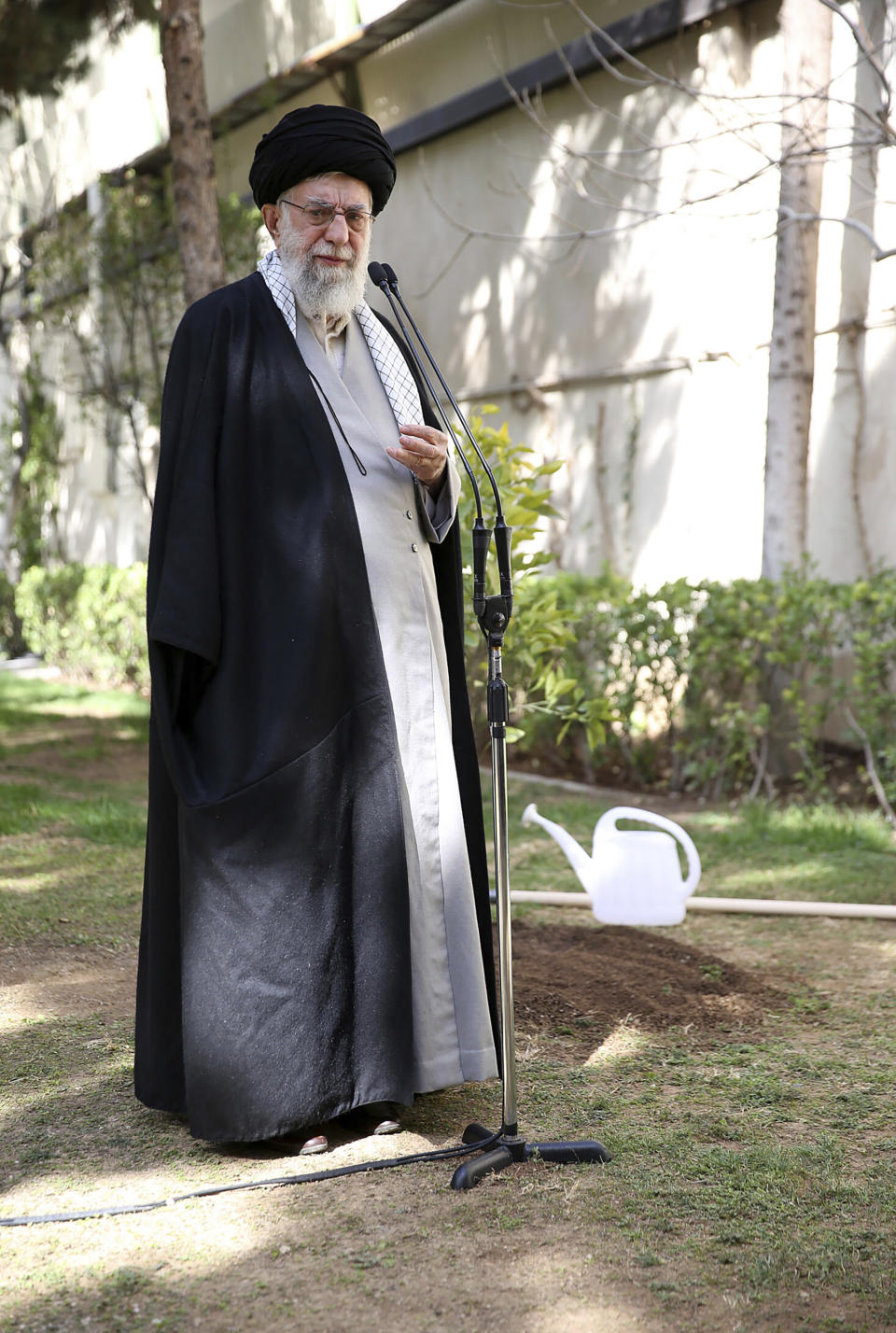 In this picture released by the official website of the office of the Iranian supreme leader, Supreme Leader Ayatollah Ali Khamenei speaks after planting a tree marking National Tree Planting Day, at the courtyard of his office in Tehran, Iran, Monday, March 6, 2023. Khamenei said Monday that if a series of suspected poisonings at girls' schools are proven to be deliberate the culprits should be sentenced to death for committing an "unforgivable crime." (Office of the Iranian Supreme Leader via AP)