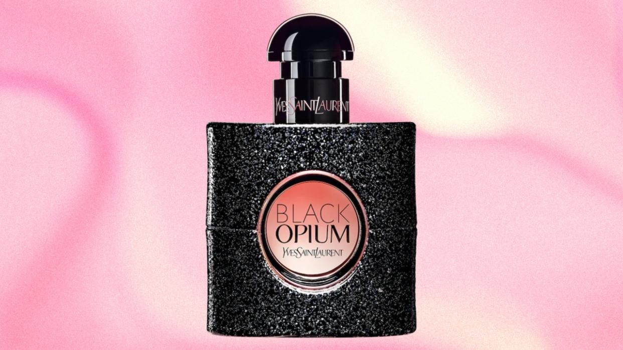  A bottle of Black Opium by YSL on a pink and cream marbled template. 