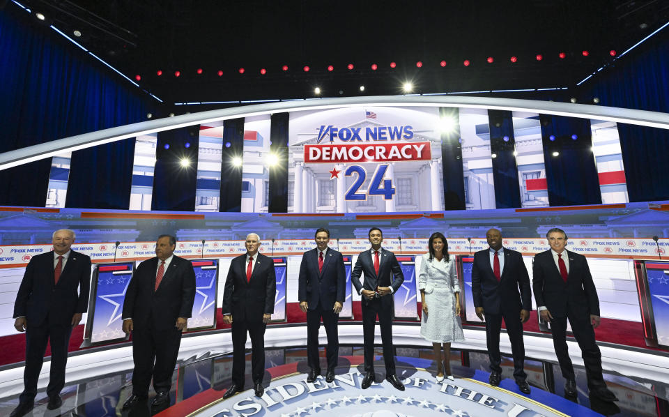 MILWAUKEE, WI - AUGUST 23:  Republican presidential candidates (L-R), former Arkansas Gov. Asa Hutchinson, former New Jersey Gov. Chris Christie, former U.S. Vice President Mike Pence, Florida Gov. Ron DeSantis, Vivek Ramaswamy, Former South Carolina governor Nikki Haley, Sen. Tim Scott (R-SC) and North Dakota governor Doug Burgum are introduced before a debate hosted by Fox News in Milwaukee, Wisconsin, US, on Wednesday, Aug. 23, 2023 at the Fiserv Forum. Republican presidential contenders, minus former president Donald Trump, will face off tonight in their first debate of the primary season. 
(Photo by Joshua Lott/The Washington Post via Getty Images)