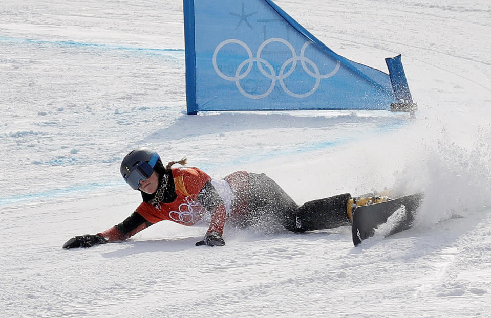 FILE - Ladina Jenny, of Switzerland, crashes during the women's parallel giant slalom elimination run at Phoenix Snow Park at the 2018 Winter Olympics in Pyeongchang, South Korea, Saturday, Feb. 24, 2018. Still bothering many of the riders was the way the slopestyle contests went down at the Pyeongchang Games four years ago. The women's contest was held in windy, subpar conditions while, across the mountain, the Alpine race was called off. (AP Photo/Kin Cheung)