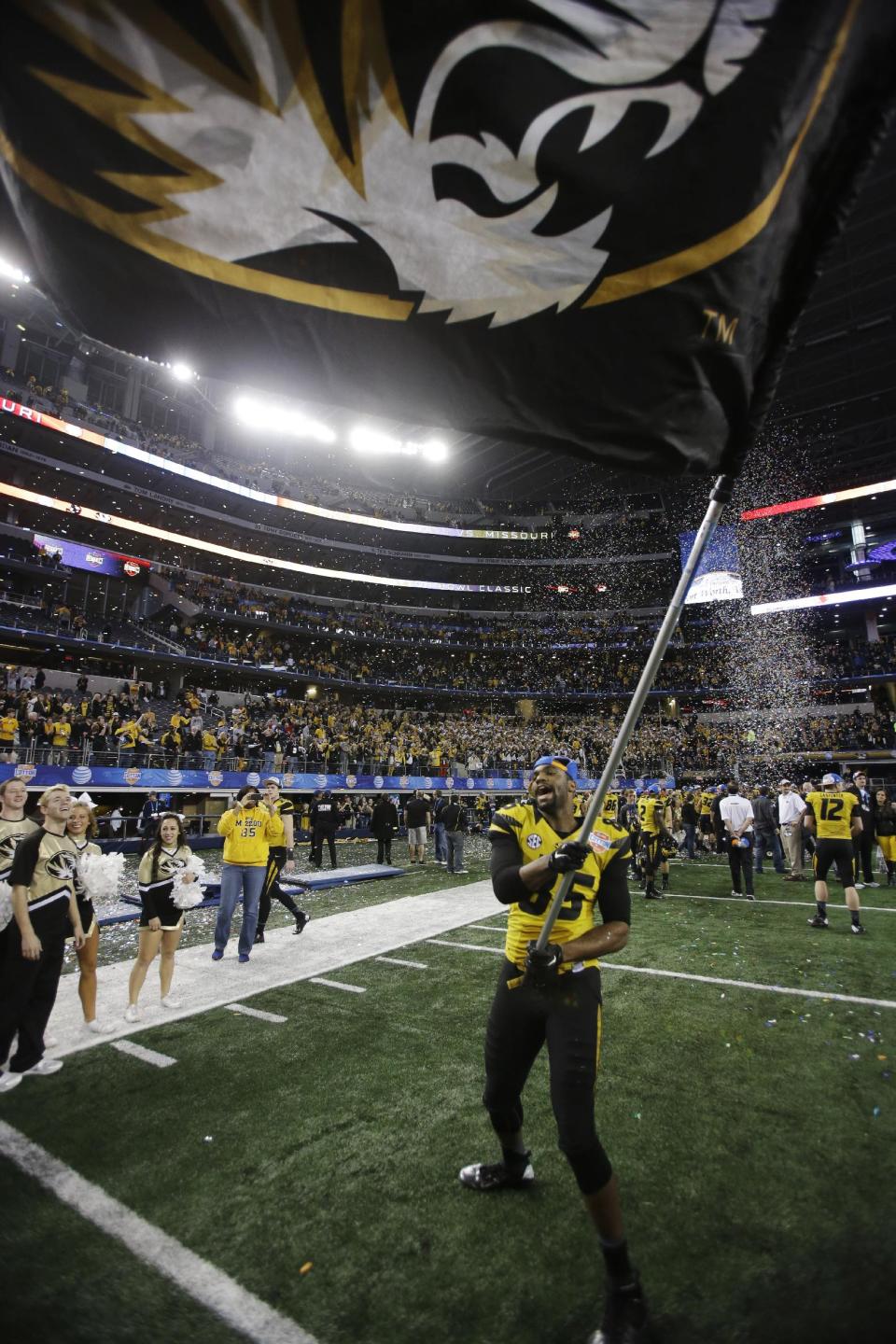 Missouri wide receiver Marcus Lucas (85) waves the school's flag after the Cotton Bowl NCAA college football game against Oklahoma State, Friday, Jan. 3, 2014, in Arlington, Texas. Missouri won 41-31. (AP Photo/Tim Sharp)