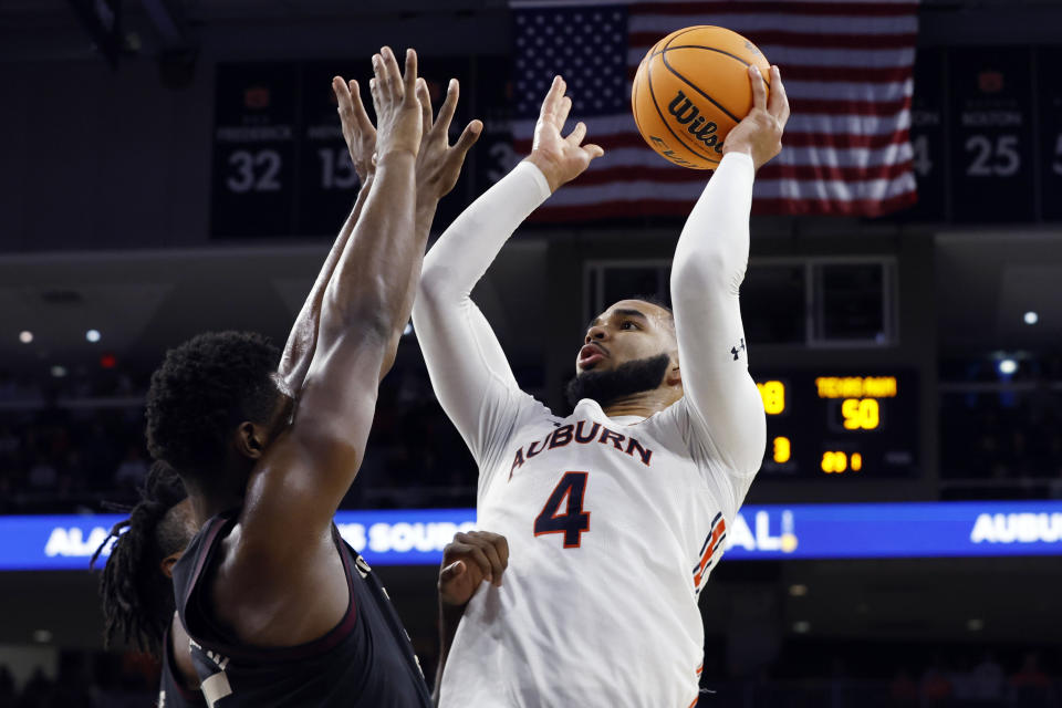 Auburn forward Johni Broome (4) shoots over Texas A&M forward Julius Marble and forward Henry Coleman III during the second half of an NCAA college basketball game Wednesday, Jan. 25, 2023, in Auburn, Ala.. (AP Photo/Butch Dill)