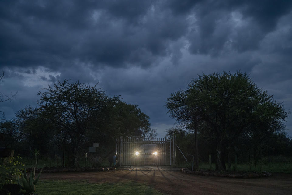 Customers arrive under storm clouds at the Tamboti Bush Lodge in the Dinokeng game reserve near Hammanskraal, South Africa, Saturday Dec. 4, 2021. Recent travel bans imposed on South Africa and neighboring countries as a result of the discovery of the omicron variant in southern Africa have hammered the country’s safari business, already hard hit by the pandemic. (AP Photo/Jerome Delay)