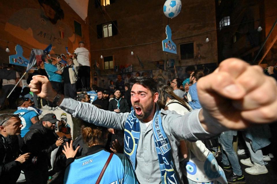 Fans of SSC Napoli gathering at the Largo Maradona in the Quartieri Spagnoli district on May 4, 2023 in Naples to watch a live broadcast of a potentially decisive match between Udinese and Napoli played in Udine (AFP via Getty Images)