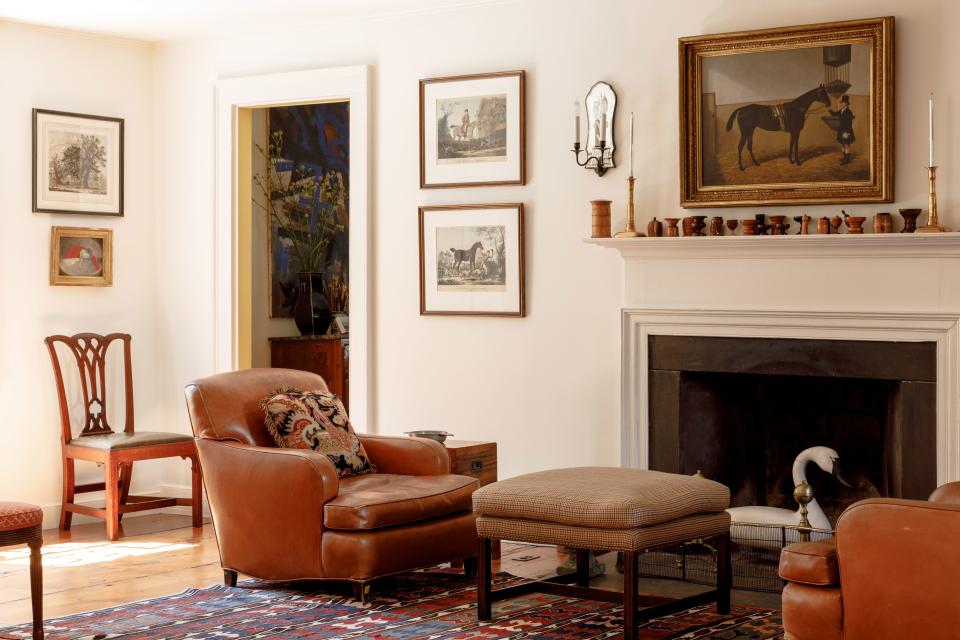 In this cozy section of Steinhart’s sitting room, a pair of leather chairs rescued from a repository in the Racquet and Tennis Club of New York sit in front of the fireplace. Above the mantle are some of Steinhart’s prized antique treenware pieces.