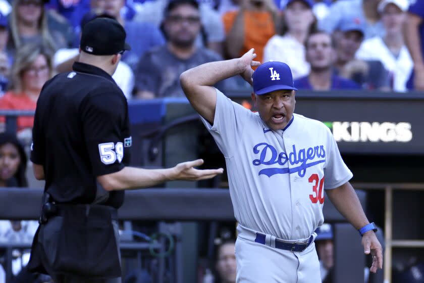 Los Angeles Dodgers manager Dave Roberts, right, yells at home plate umpire Nic Lentz, left, during the third inning of a baseball game against the New York Mets, Thursday, Sept. 1, 2022, in New York. (AP Photo/Adam Hunger)
