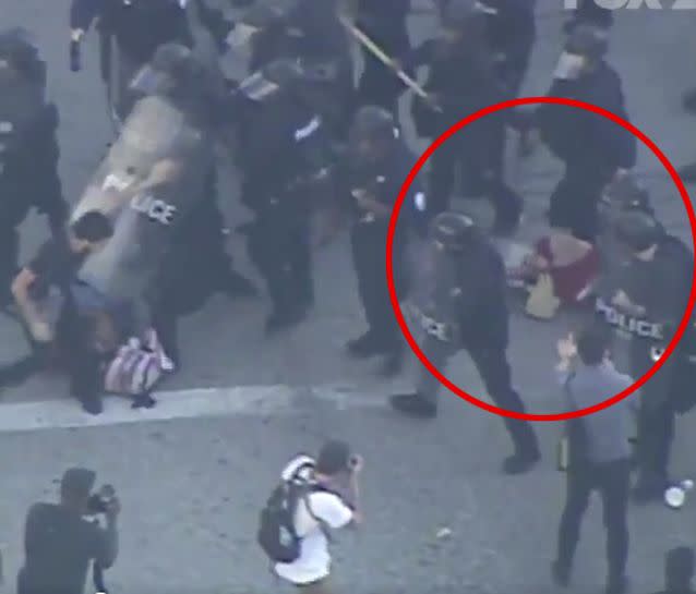 The riot police walked over the woman as they cleared the streets. Source: Fox2