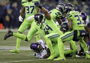 FILE - In this Monday, Dec. 10, 2018, file photo, Seattle Seahawks' Bobby Wagner (54) raises his fist after stopping Minnesota Vikings' Latavius Murray on a fourth down run in the second half of an NFL football game in Seattle. Wagner, making a hefty statement for NFL Defensive Player of the Year, seeks his eighth straight game with at least eight tackles. (AP Photo/Stephen Brashear, File)