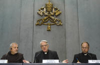 Vatican spokesperson, Father Federico Lombardi, centre, introduces Mons. Slawomir Oder, right, postulator of late Pope John Paul II, and Father Giovangiuseppe Califano, postulator of late Pope John XXIII, during a press conference at the Vatican, Tuesday, April 22, 2014. On Sunday, April 27, 2014, Pope Francis will elevate to sainthood the two popes. (AP Photo/Domenico Stinellis)