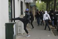 A youth breaks a bank window during a demonstration to protest the the government's proposed labor law reforms in Nantes, France, May 26, 2016. REUTERS/Stephane Mahe