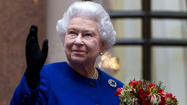 PHOTO: Britain's Queen Elizabeth II looks up and waves to members of staff of The Foreign and Commonwealth Office as she ends an official visit, which is part of her Jubilee celebrations in London, Dec. 18, 2012. (Alastair Grant/Pool/AP)