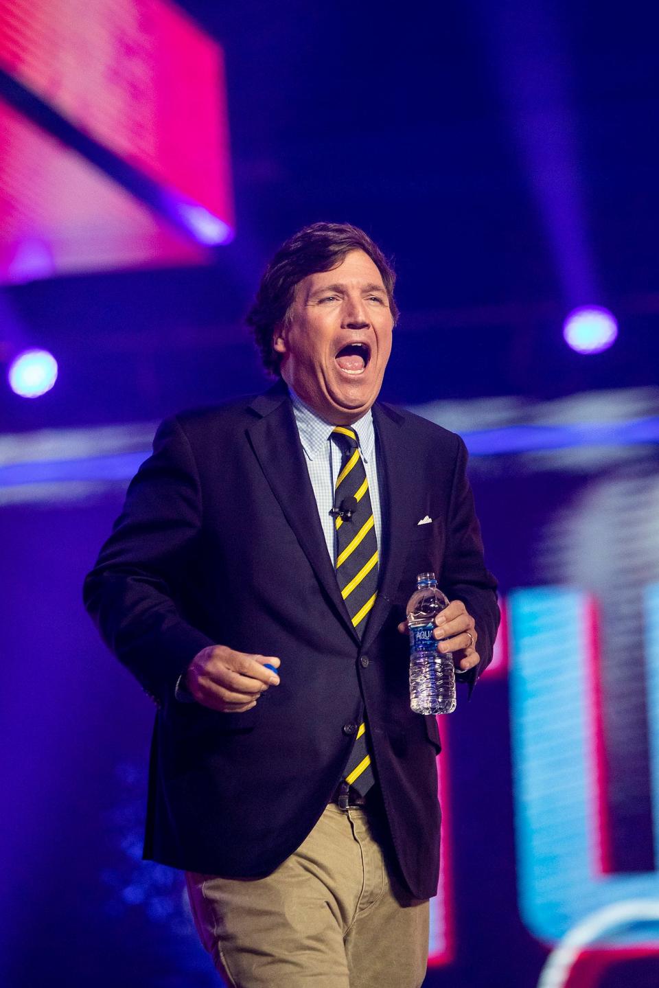 Tucker Carlson speaks during the first day of the AmericaFest hosted by Turning Point USA on Saturday, Dec. 18, 2021, in Phoenix.