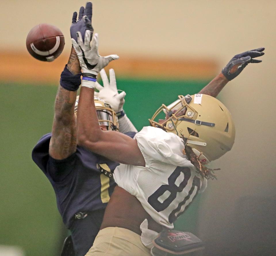 University of Akron defensive back Chu Ogbonna, left, breaks up a pass in the end zone intended for Jasaiah Gathings during the team's Blue & Gold Spring Game on Saturday at Stile Field House.