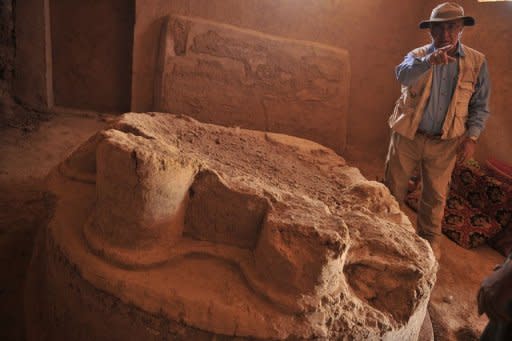 Zemaryalai Tarzi, Afghan-born French archaeologist, stand next to an archaeological artifact in Bamiyan. Tarzi says he dug first in the potato fields to find artefacts, which he buried again afterwards. All around him, under a large area of farmland, he says, lie exceptional treasures