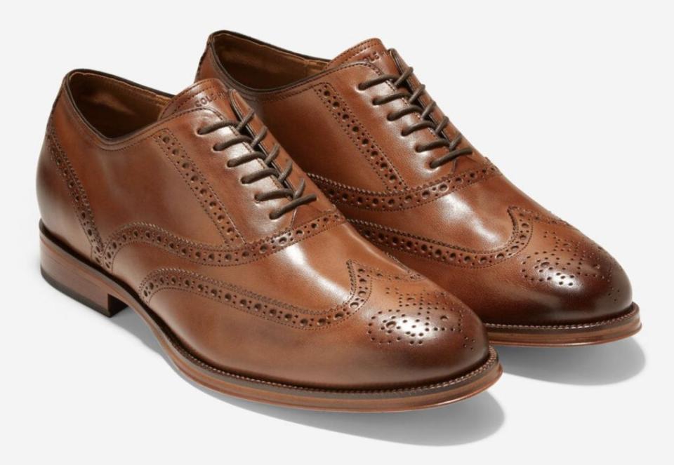 A p air of brown oxford wingtip shoes.