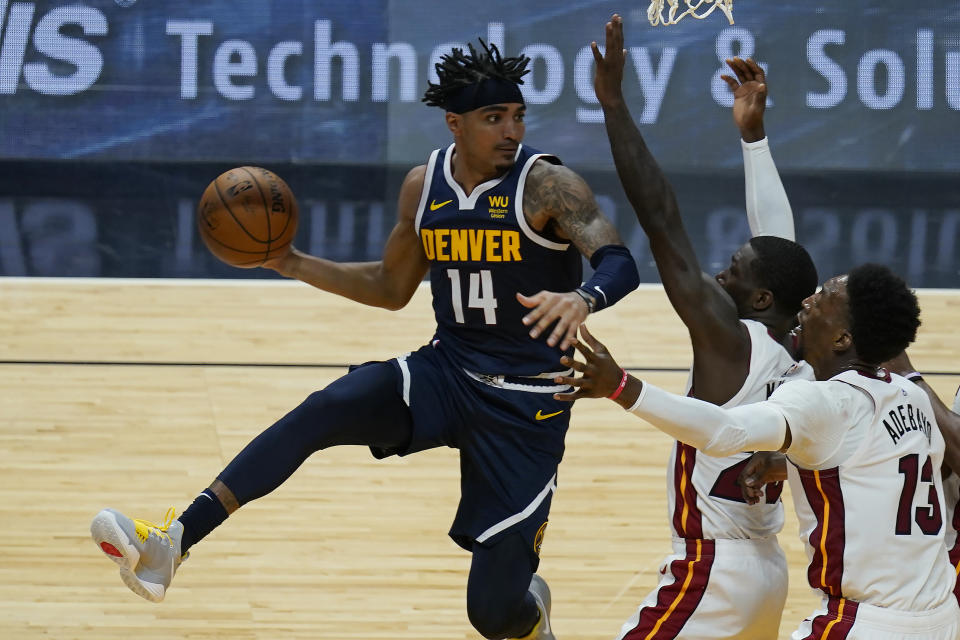 Denver Nuggets guard Gary Harris (14) looks to pass the ball as Miami Heat center Bam Adebayo (13) and guard Kendrick Nunn (25) defend and during the first half of an NBA basketball game, Wednesday, Jan. 27, 2021, in Miami. (AP Photo/Marta Lavandier)