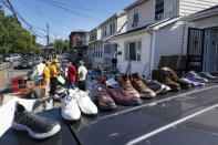 FILE - In this Sept. 3, 2021, file photo, shoes dry on the roof of a car in the Queens borough of New York. Floodwaters from the remnants of Hurricane Ida have long receded but Northeast residents still in the throes of recovery are being hit with another unexpected blow: Thousands of families without flood insurance are now swamped with financial losses after runoff from the fierce storm submerged basements, cracked foundations and destroyed valuable belongings. (AP Photo/Mark Lennihan, File)