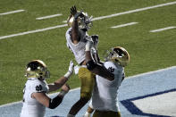 Notre Dame running back Kyren Williams is hoisted by offensive lineman Aaron Banks (69) following Williams' touchdown against North Carolina during the second half of an NCAA college football game in Chapel Hill, N.C., Friday, Nov. 27, 2020. (AP Photo/Gerry Broome)