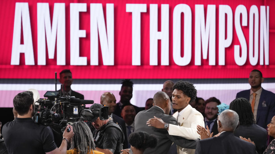 Amen Thompson hugs family and friends after being selected fourth overall by the Houston Rockets during the NBA basketball draft, Thursday, June 22, 2023, in New York. (AP Photo/John Minchillo)