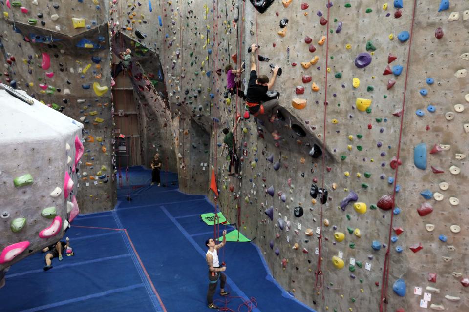 Climbers make their way up the walls at The Cliffs Climbing & Fitness, an indoor rock climbing facility in Valhalla Oct. 26, 2023.