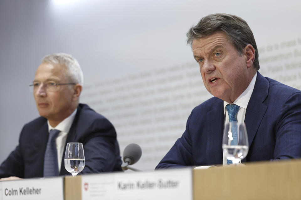 Axel Lehmann, Chairman Credit Suisse, left, sits beside Colm Kelleher, Chairman UBS, during a press conference in Bern, Switzerland, Sunday March 19, 2023. Banking giant UBS is acquiring its smaller rival Credit Suisse in an effort to avoid further market-shaking turmoil in global banking, Swiss President Alain Berset announced on Sunday. Sunday’s news conference by the Federal Council, the seven-member governing body that includes Berset, follows the collapse of two large U.S. banks last week that spurred a frantic, broad response from the U.S. government to prevent any further bank panics. (Peter Klaunzer/Keystone via AP)