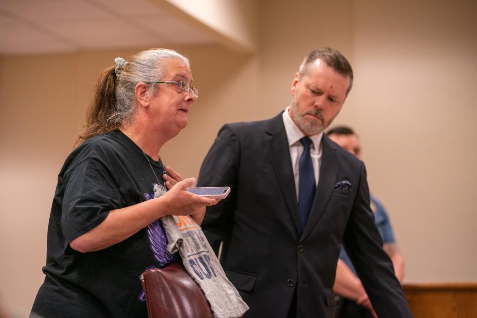Karen Uyar, holding a shirt that reads "Mother's Little Cutie,” speaks to Superior Court Judge John M. Deitch about how the death of her daughter, Yasemin Uyar, has affected her 3-year-old grandson, Sebastian. The boy was wearing the shirt on the day he watched his father, Tyler Rios, choke his mother to death.