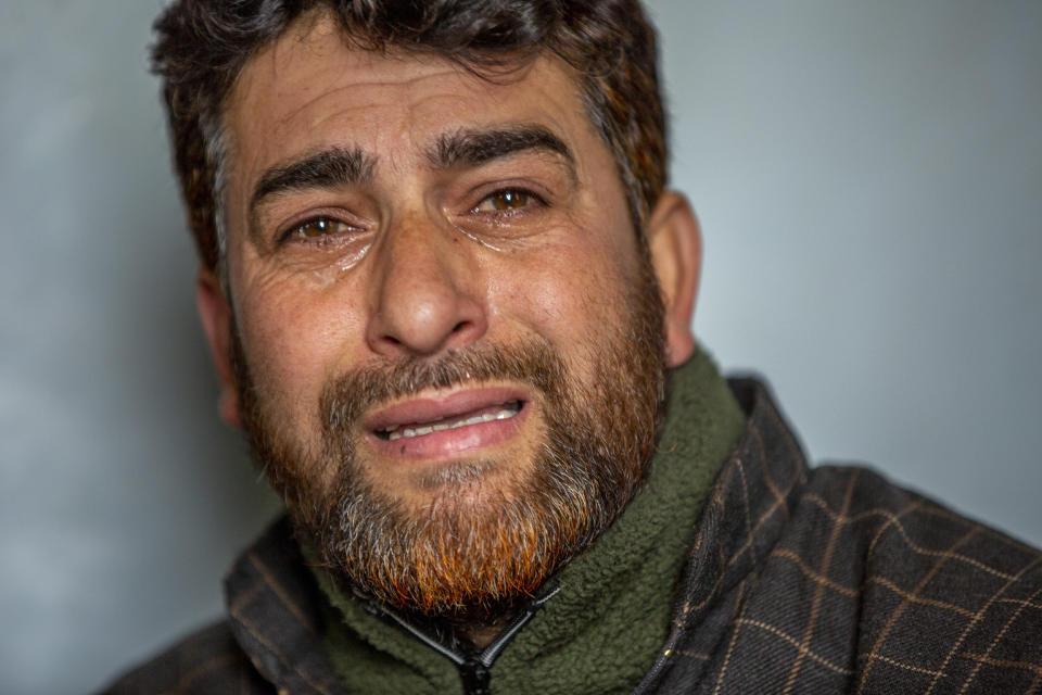 Mushtaq Ahmad Wani, father of 16-year-old Athar Mushtaq, breaks down while talking to Associated Press in Bellow, south of Srinagar, Indian controlled Kashmir, Tuesday, Jan. 5, 2021. On the last week of 2020, Indian government forces killed Athar and two other young men during a controversial gunfight on the outskirts of the Indian-controlled Kashmir’s main city. Police did not call them anti-India militants but “hardcore associates of terrorists." They later buried them at a graveyard in a remote mountainous tourist resort miles away from their ancestral villages. Athar was the latest Kashmiri to be buried in a far-off graveyard after Indian authorities in a new controversial policy in 2020 started to consign blood-soaked bodies of scores of Kashmiri suspected rebels to unmarked graves, denying the mourning families a proper funeral and a burial. (AP Photo/ Dar Yasin)