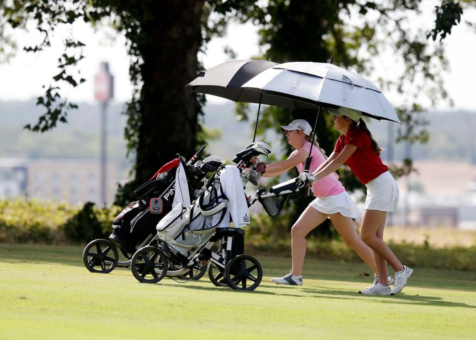 Aidan Coffelt from Edmond North and Olivia Coit from Edmond Memorial during the All-State golf tournament at Cherokee Hils Golf Club in Catoosa, OK, July 25, 2022.