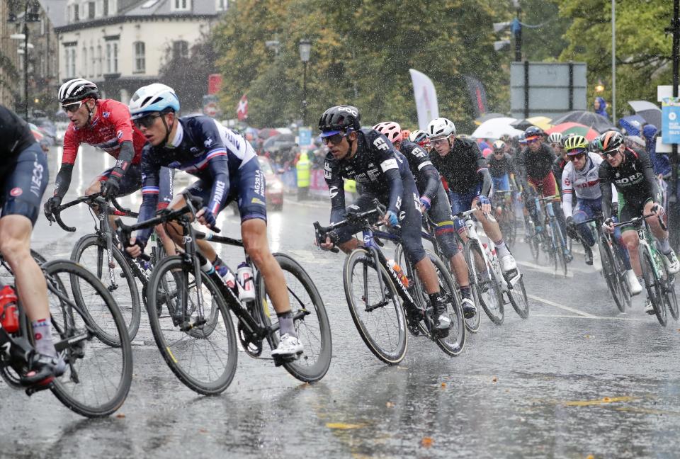 Cyclists ride under pouring rain during the men elite race, at the road cycling World Championships in Harrogate, England, Sunday, Sept. 29, 2019. (AP Photo/Manu Fernandez)