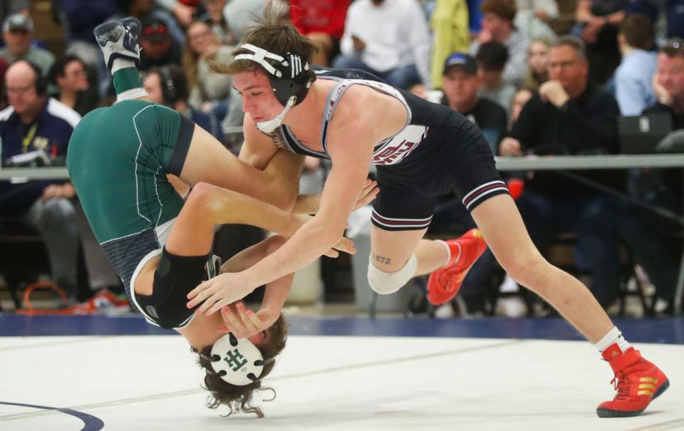 Caravel's Luke Poore (right) wrestles to a win by pin for the title at 132 pounds against Tower Hill's Drew Pratt in the Delcastle Invitational, Saturday, Jan. 7, 2023 at Delcastle Technical High School.