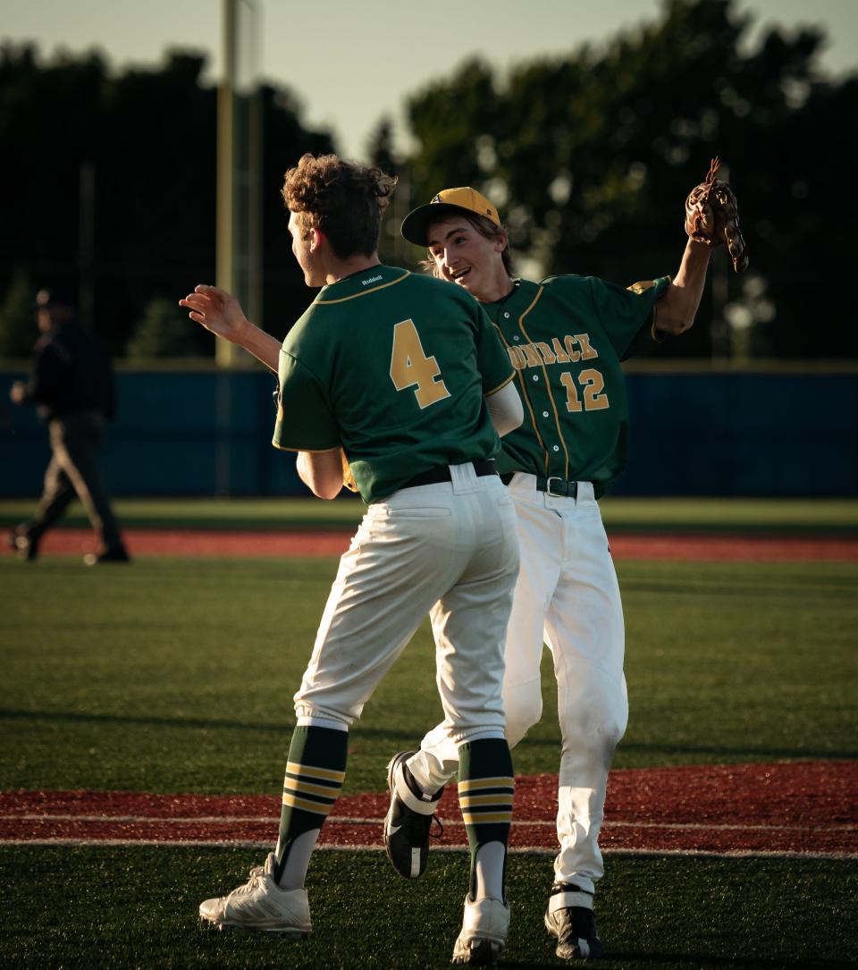 Bailey Gleasman (4) and Alexander Kaun (12) celebrate after Gleasman catches a pop-up for the final out of the game that sends them to Binghamton for states. Adirondack beat Lansing 2-1 at Onondaga Community College on Saturday, June 4, 2022.