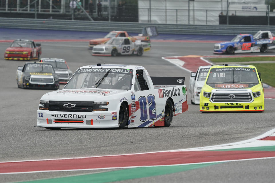 Kaz Grala (02) leads the field into Turn 13 on the first lap of the NASCAR Truck Series auto race at the Circuit of the Americas in Austin, Texas, Saturday, May 22, 2021. (AP Photo/Chuck Burton)