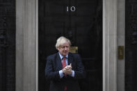 Britain's Prime Minister Boris Johnson joins in the applause on the doorstep of 10 Downing Street in London during the weekly "Clap for our Carers" Thursday, May 7, 2020. The COVID-19 coronavirus pandemic has prompted a public display of appreciation for care workers. The applause takes place across Britain every Thursday at 8pm local time to show appreciation for healthcare workers, emergency services, armed services, delivery drivers, shop workers, teachers, waste collectors, manufacturers, postal workers, cleaners, vets, engineers and all those helping people with coronavirus and keeping the country functioning while most people stay at home in the lockdown. (AP Photo/Alberto Pezzali)