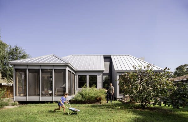 Keeping ample green space on the property was a top-tier goal. One of the house's original screened-in porches remains, but, according to Emily, "we dropped the screens so when you're sitting in the dining room, you can look out and see the bamboo." The divide between the new and old sections is marked by a gap in the roof that lets the sun into a small planted area. 