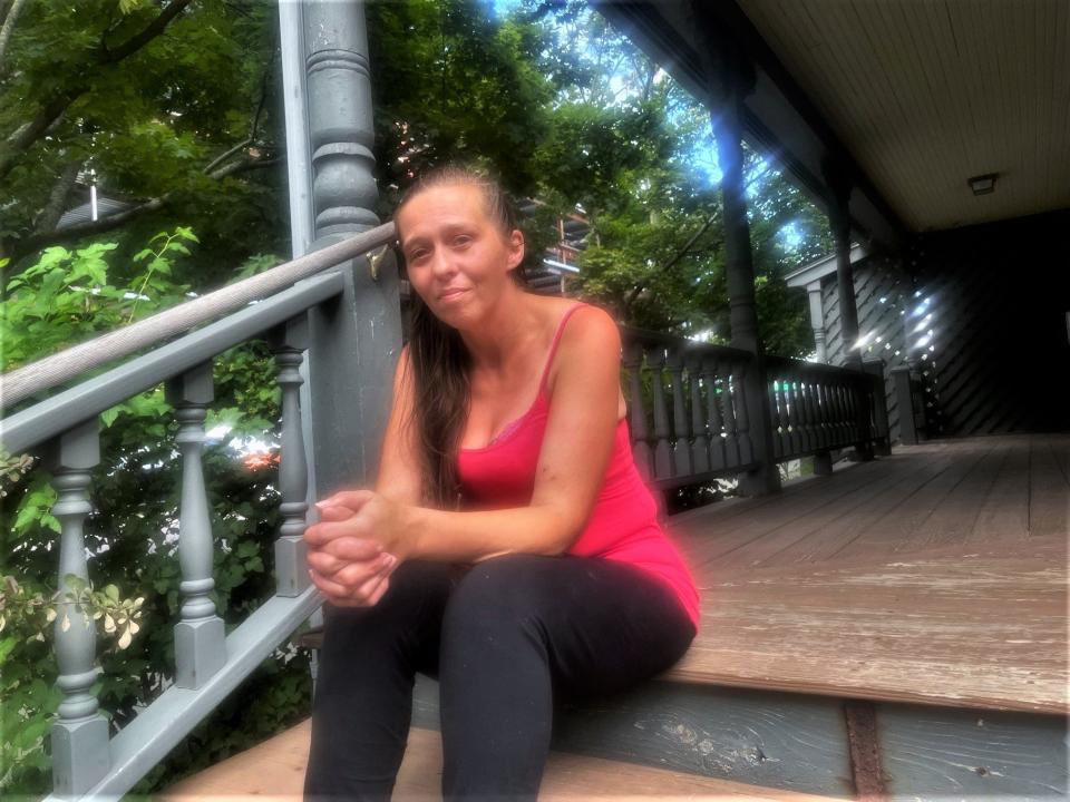 Jeannie Morrill sits on the steps of the downtown office of Vermonters for Criminal Justice Reform, as seen on Aug. 30, 2023.