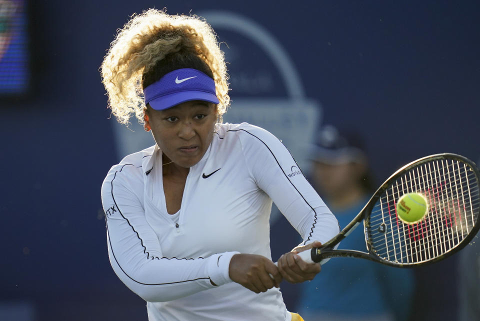 Naomi Osaka, of Japan, hits a return to Coco Gauff, of the United States, at the Mubadala Silicon Valley Classic tennis tournament in San Jose, Calif., Thursday, Aug. 4, 2022. (AP Photo/Godofredo A. Vásquez)