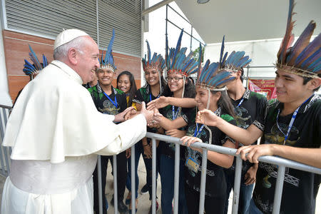 Pope Francis is welcomed as he arrives at the Puerto Maldonado's airport, Peru. Osservatore Romano/Handout via REUTERS