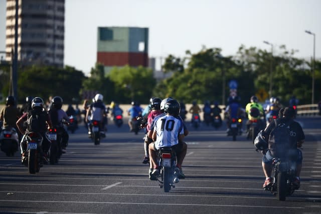 The hearse carrying Diego Maradona’s body was followed by fans on its way to the cemetery in Buenos Aires