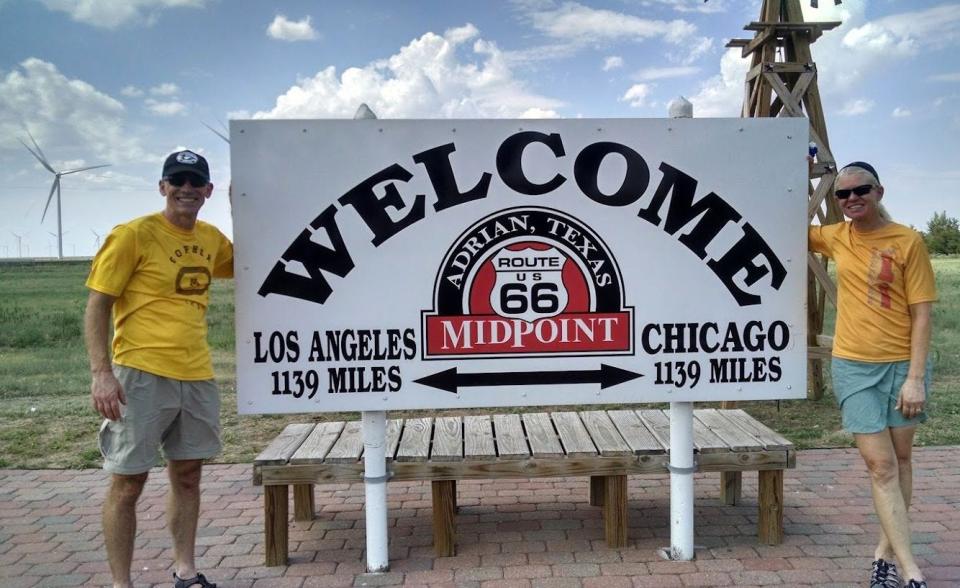 Peter and Tracy Flucke stop for a photo break at the halfway point on their Route 66 bicycling adventure.