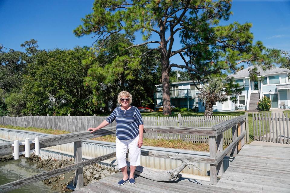 Kathryn Williams stands on the dock at her Tybee Island home.