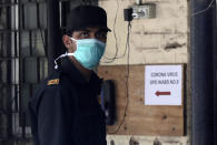 A security officer wears a mask outside a special ward set aside for possible COVID-19 patients, in Mumbai, India, Thursday, March 5, 2020. A new virus first detected in China has infected more than 90,000 people globally and caused over 3,100 deaths. The World Health Organization has named the illness COVID-19, referring to its origin late last year and the coronavirus that causes it. (AP Photo/Rajanish Kakade)