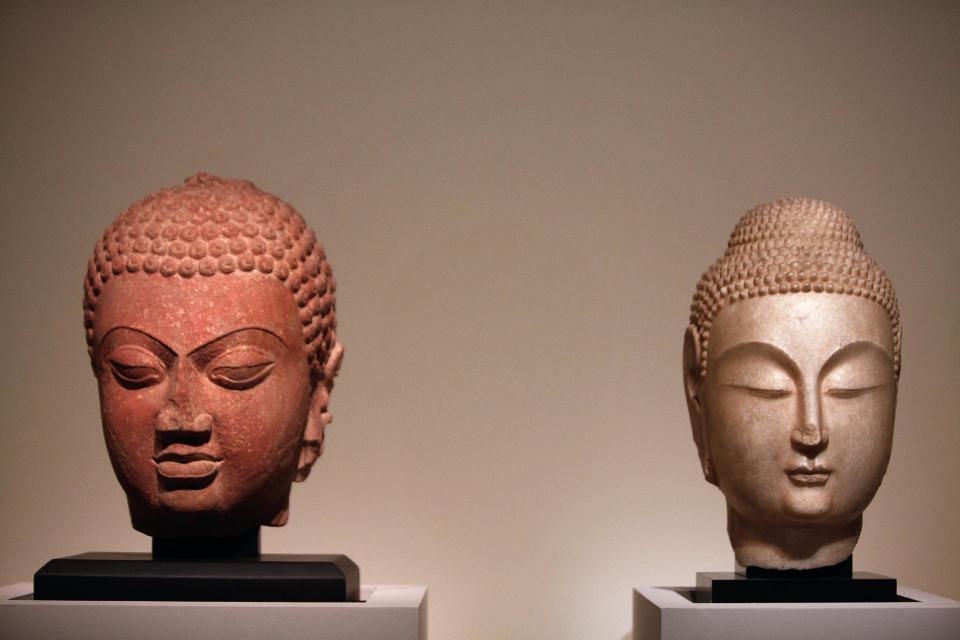 Buddha Heads from Northern China (534-550 bc), right, and from Northern India, fifth century are displayed as part of the exhibition "Louvre Abu Dhabi. Birth of a museum", at the Louvre museum, in Paris, Monday, April 28, 2014. The Louvre Abu Dhabi, the Persian Gulf’s first ever world museum, will open its doors in December 2015 in the arid Arab federation. Several thousand kilometers away on Tuesday the Louvre in Paris previewed the art that the Abu Dhabi project has acquired since 2009 for the first time to a European audience. (AP Photo/Thibault Camus)