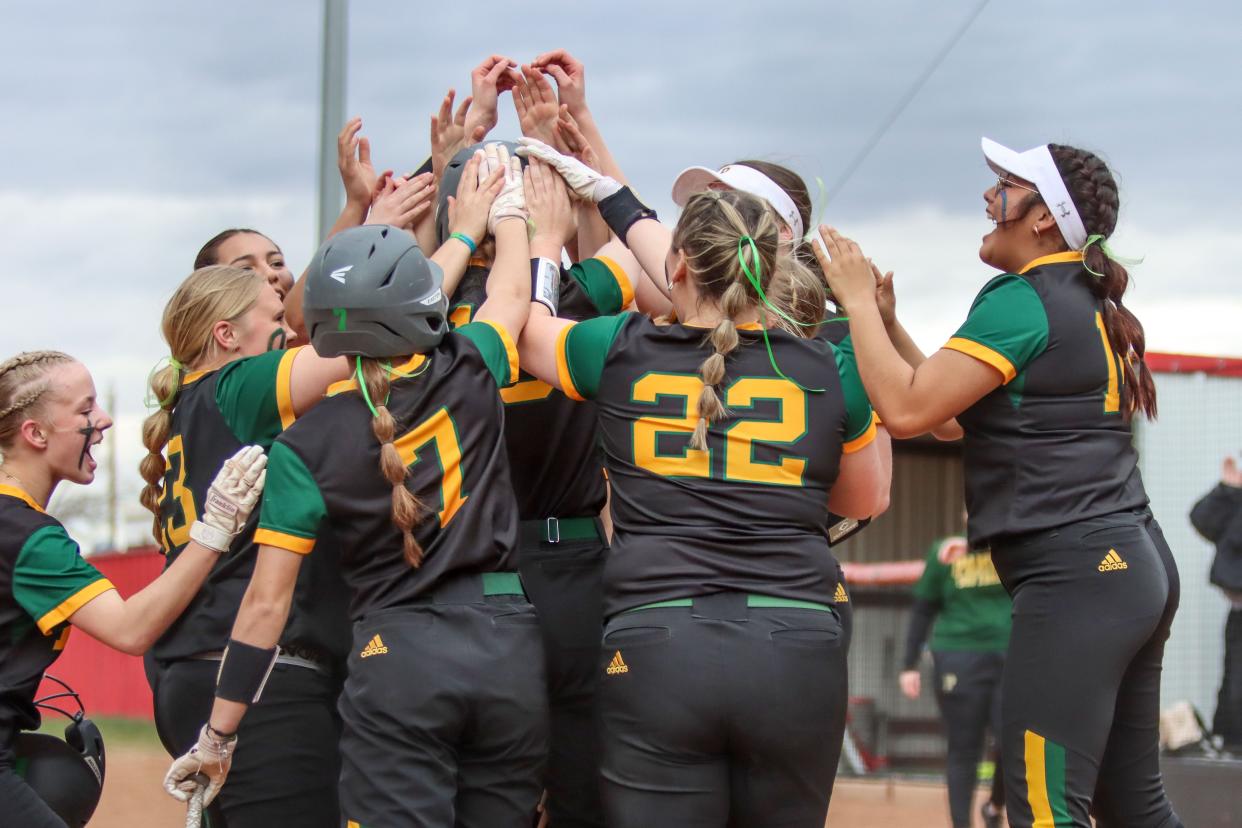 Pampa celebrates Maecie Hawthorne (16) at home plate after she hit a home run in a District 4-4A game against Borger, Tuesday, March 21, 2023, at Borger High School Softball Field in  Borger.  Pampa won 11-1.