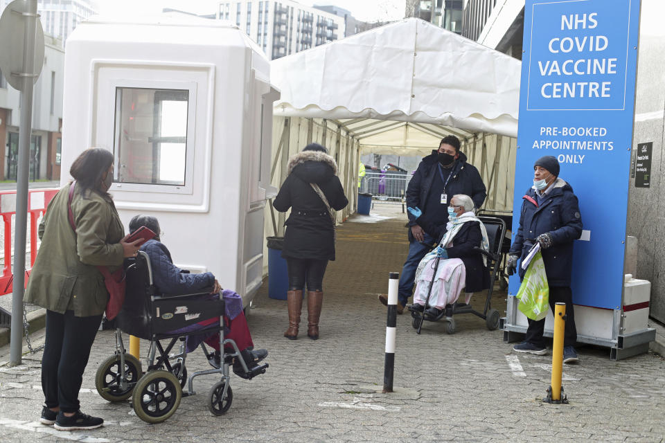 Members of the public wait in line outside the vaccination centre at Wembley, north London, as ten further mass vaccination centres opened in England, Monday Jan. 18, 2021. (Yui Mok/PA Wire(/PA via AP)