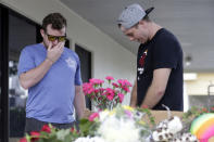 <p>Dave Allen, left, and Ryan Caviness, pray for the victims of a deadly shooting outside the Club Blu nightclub in Fort Myers, Fla., Monday, July 25, 2016. (AP Photo/Lynne Sladky)</p>