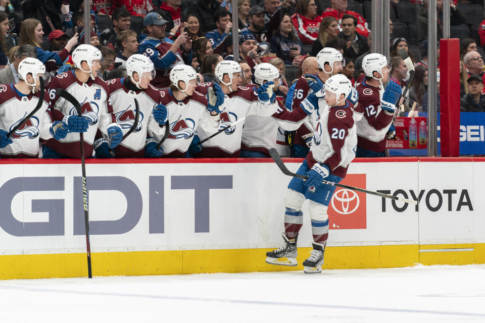 Colorado Avalanche center Ross Colton (20) celebrates with teammates after scoring during the first period of an NHL hockey game against the Washington Capitals, Tuesday, Feb. 13, 2024, in Washington. (AP Photo/Stephanie Scarbrough)